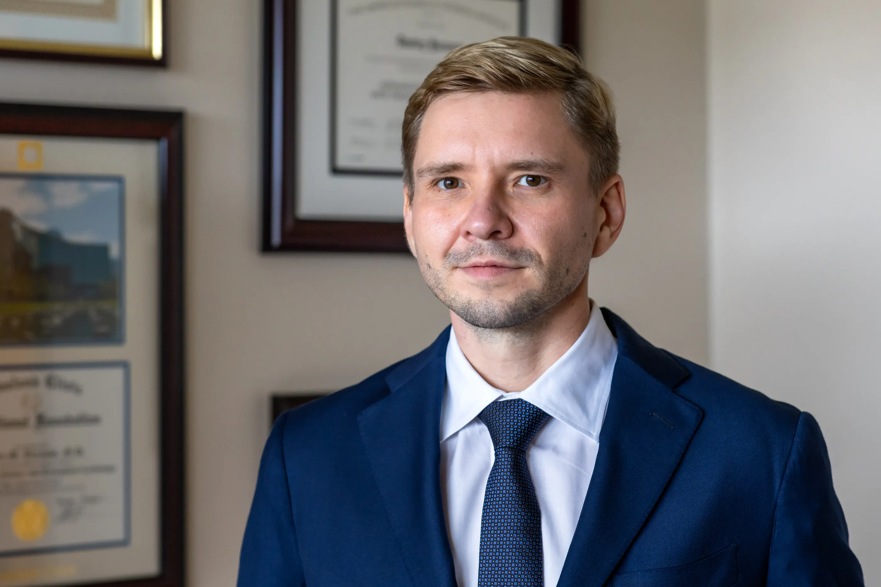 Dr. Yaranov in a navy suit, smiling at the camera
