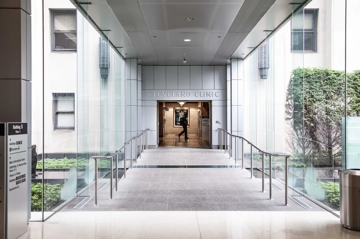 The Cleveland Clinic entrance corridor, glass walls on both sides and the name above the doorway